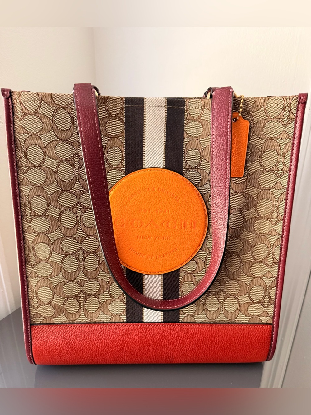 Coach Monogram Tote with Orange Medallion and Red Trim